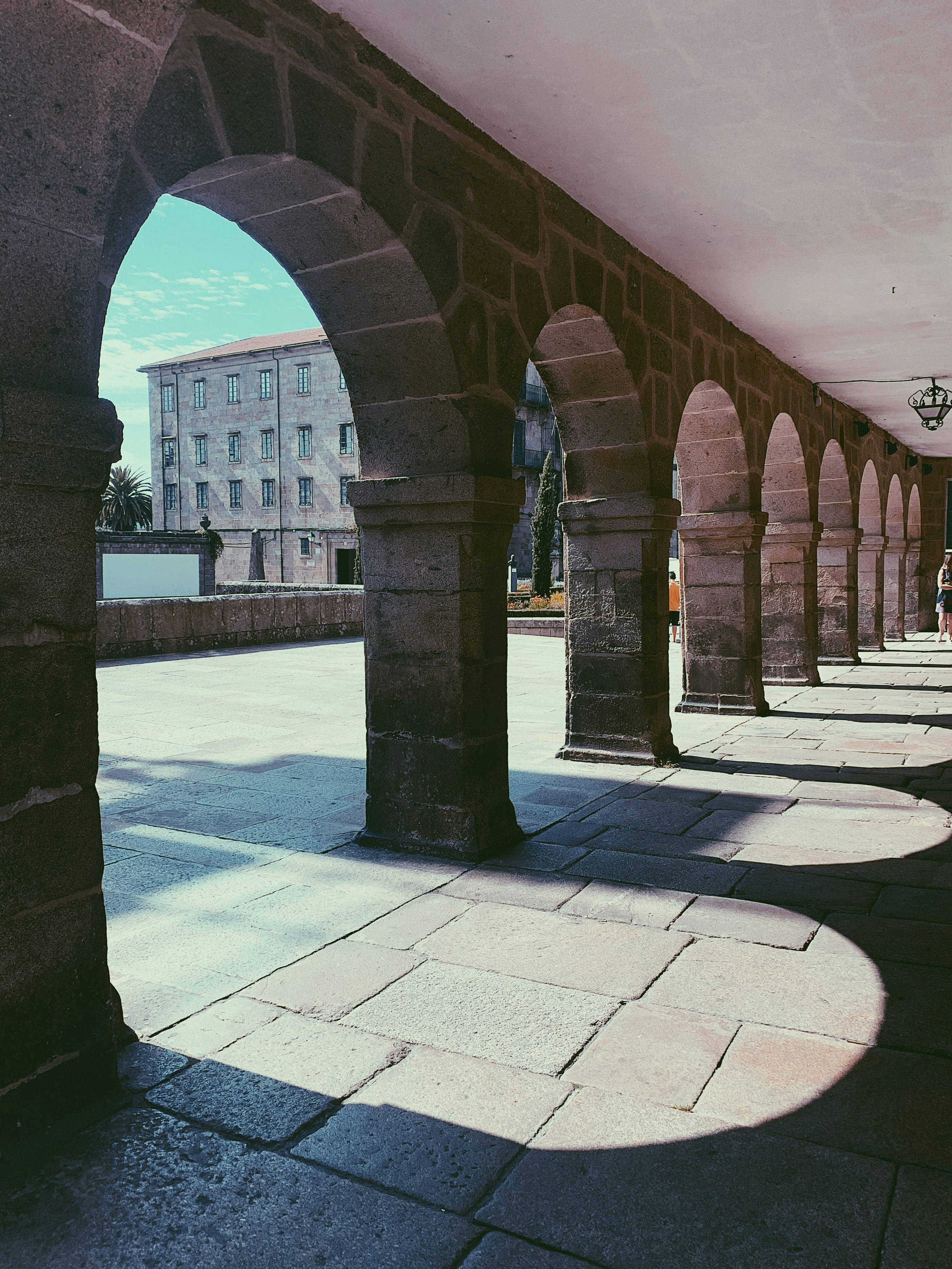 brown concrete archways facing sea